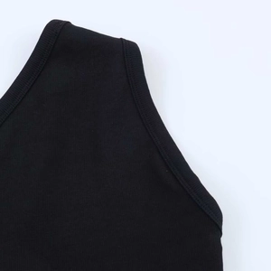 Detail of black ribbed knit fabric and seamless shoulder strap stitching on the bodysuit