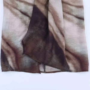Detailed macro view of abstract gradient print on lightweight brown midi skirt fabric