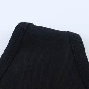 Close-up of black ribbed knit fabric detail on a one-shoulder summer jumpsuit