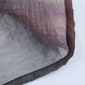 Close-up of woven fabric texture with gradient brown tones and reinforced edge stitching