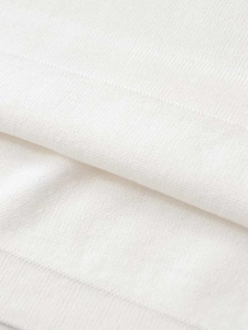 Close-up of premium fine knit white fabric texture with soft breathable finish