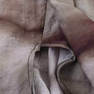 Detail showing the brown gradient fabric texture and clean hem stitching of the skirt