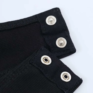 Close-up of black ribbed knit fabric with four silver metal snap buttons on bodysuit