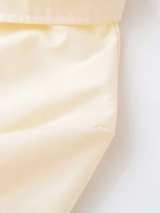 Macro detail of high-density cotton fabric with fine stitching on ivory shirt collar