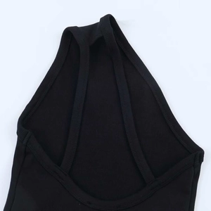 Detail of black ribbed knit bodysuit showing the halter neckline and fine stitching