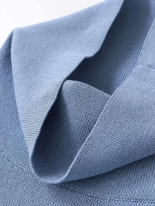 Close-up of the high-density ribbed knit fabric texture in elegant dusty blue color