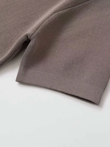 Close-up of taupe short sleeve knit sweater showing detailed vertical rib knit texture