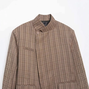Brown plaid blazer with mandarin collar and asymmetric button closure in a flat lay view