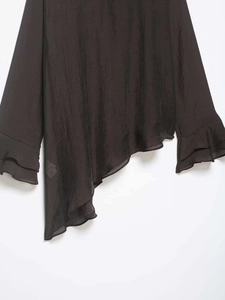 Detailed view of women long-sleeve top with asymmetric hem and double-layered ruffle cuffs