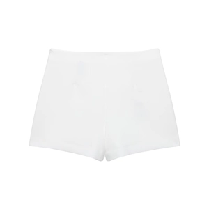 Detailed close-up of white high-waisted asymmetric skort featuring smooth woven fabric texture