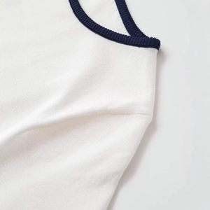 Short sleeve knit top with white fabric and navy blue contrast ribbed crew neck
