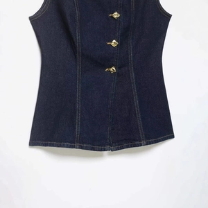 Classic dark blue denim vest with vintage yellow stitching and unique gold geometric buttons