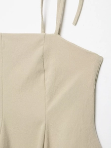 Detailed close-up of khaki textured fabric and delicate thin straps on a camisole top
