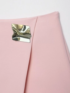 Detail of pink skirt pants with irregular wavy metallic ornament and twill texture fabric