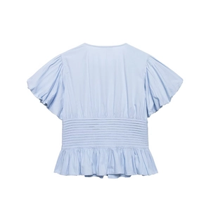 Light blue puff sleeve shirt with waist pleats and ruffle hem on white background