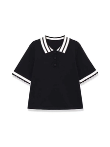 Detail of contrast stripe polo collar and lettuce trim short sleeves on a black knit top