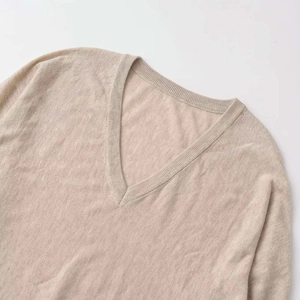 Minimalist oatmeal V-neck knit pullover sweater featuring soft cashmere blend texture
