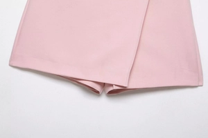 Detailed close-up of light pink asymmetrical skort showing fabric texture and neat stitching