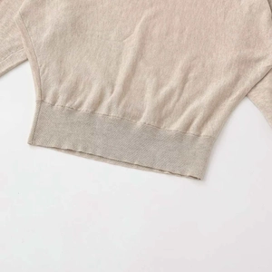 Chic beige V-neck knit sweater featuring batwing sleeves and ribbed hem texture
