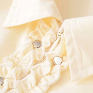 Pale yellow blouse with ruffled collar and silver snap button detail on high quality cotton