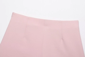 Detail of light pink high-waist skort featuring a hidden side zipper and tailored seams