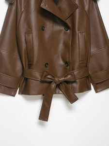 Detail view of brown faux leather jacket with lychee texture and belted waist
