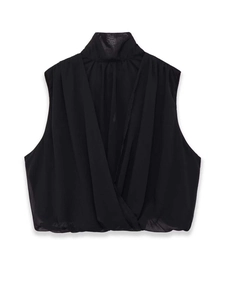 Detailed view of the elegant wrap front drape and sheer chiffon fabric on a black blouse
