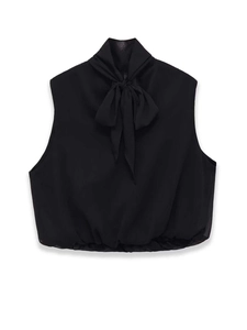 Detail of black chiffon sleeveless top featuring elegant bow tie neck and elastic hemline