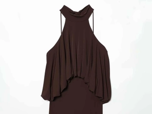 Detail of elegant dark brown halter neck maxi dress with fluid layered ruffles