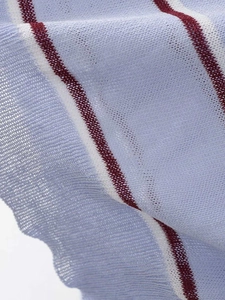 Detailed macro shot of the textured mesh knit fabric with colorful horizontal stripes