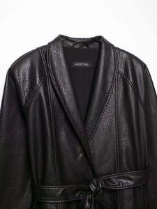 Close-up of Indefeir black faux leather jacket showing litchi texture and shawl collar