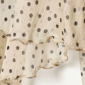 Chiffon polka dot blouse with pleated fabric and ruffled hem in beige and black