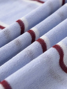 Macro shot of striped knit fabric showing soft texture in light blue, white and dark red