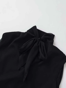 Close-up of black sleeveless chiffon blouse featuring an elegant pussy-bow neck tie