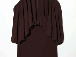 Detail of dark brown balloon-style dress featuring a layered cape design and fluid drape