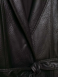 Detailed macro shot of premium black faux leather texture with waist belt buckle detail