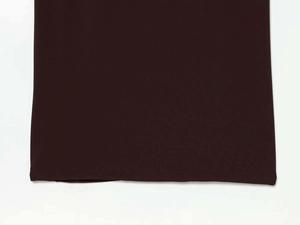 Close-up of the double-stitched hem on a chocolate brown knitted halter maxi dress