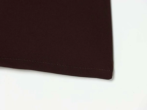 Detailed close-up showing the precise single-needle stitching on the dark brown knit fabric