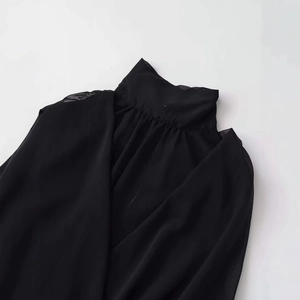 Elegant sleeveless black chiffon blouse with high collar and pleated neckline detail
