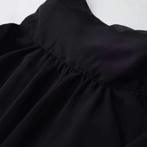 Women's black sleeveless chiffon blouse featuring a chic stand collar and pleated texture