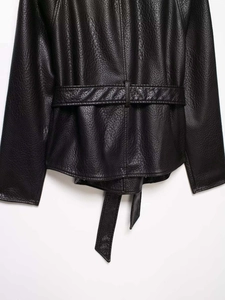 Detailed back view of black faux leather jacket featuring waist belt and lychee texture