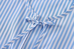 Close-up of blue and white striped poplin shirt neckline with stylish bow tie detail