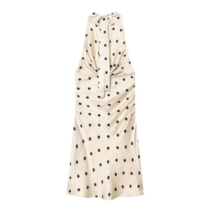 Elegant off-white satin halter dress with black polka dots and a glossy finish