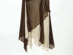 Detail of asymmetrical layered brown polka dot chiffon skirt with light inner lining
