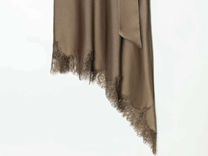 Detail of coffee silk dress showing lace trim, irregular hemline and satin waist tie