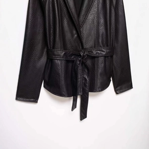 Women's black faux leather jacket with belted waist and classic turn-down collar design