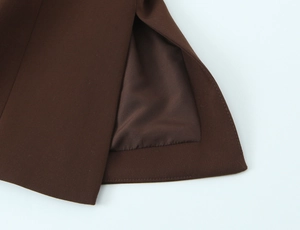 Detailed close-up of a dark brown suit vest with side slit and smooth inner lining