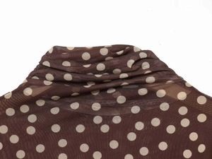 Detail of high neck mesh top in dark brown with white polka dot pattern texture