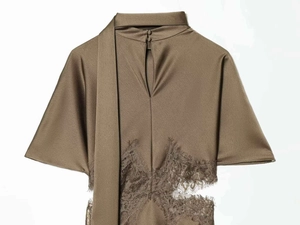 Detailed view of khaki satin blouse with high neck tie and intricate lace patchwork details