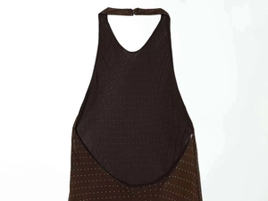Detail of dark brown halter neck dress featuring white polka dot pattern and sheer fabric